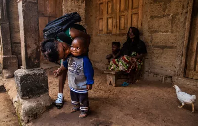 On 20 January, 18-year-old Mariatu Bangura kisses her son, Abdulai Kamara, at home before leaving for school, in Rokupr Town in Kambia District. 