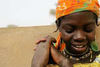 In 2007 in Niger, a girl smiles in the city of Agadez, capital of Agadez Region. She is a member of the Fulani ethnic group.