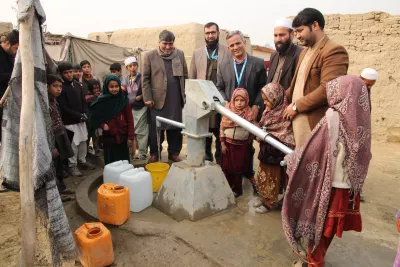 Community accessing clean water through hand pumps