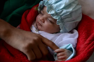 A mother holds her two days old son’s hand after giving birth in the Herat Maternity Hospital in western Afghanistan.