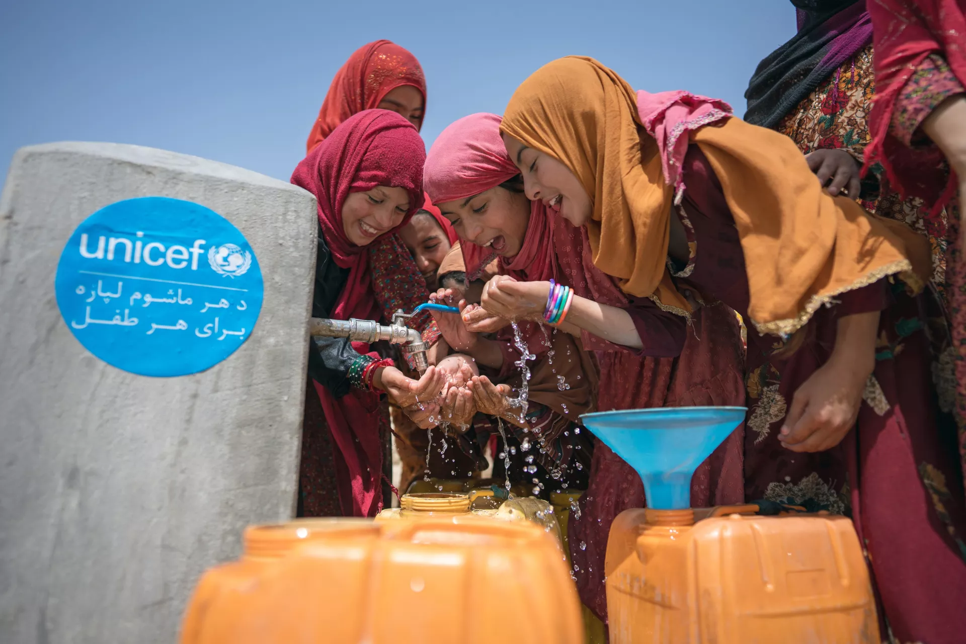 On 14th June 2023, a group of girls drink water from a tap, installed with UNICEF support, in Ahu Dara village, Sholgara District in Balkh Province, Afghanistan.