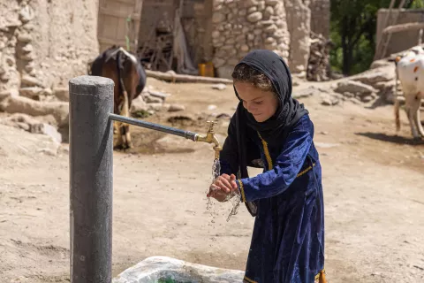 Zarghune, 6 years, washes her hands at a new water tap at her home in the remote Kani Noorbakhil Village in Spera District, Khost Province, Afghanistan. 165 families in her community now have access to clean water.