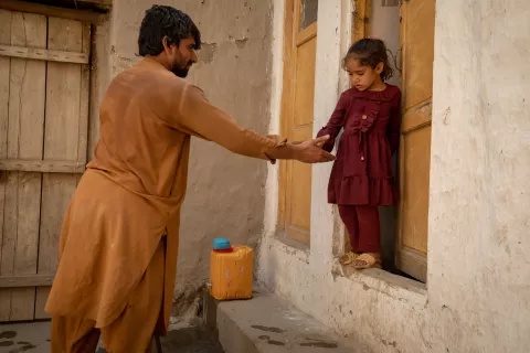 On 19 June 2023, 6-year-old Asra uses the new toilet at her home in Qarghaye District, Laghman Province, Afghanistan.