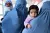 Afghan women clad in burqas hold their babies while they wait to get their children vaccinated in a hospital supported by UNICEF in the Guzzarah district of Herat province.