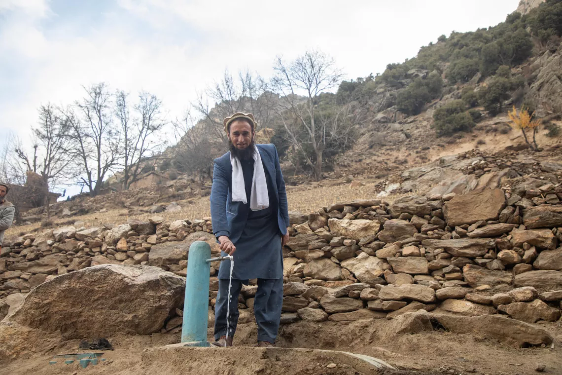 On 29 November 2023, Abdul Fatah, community elder and leader of his village's Community Development Council, stands next to a new water tap, constructed by UNICEF as part of a new gravity flow system in Payok Abad village in Nuristan province, Afghanistan.