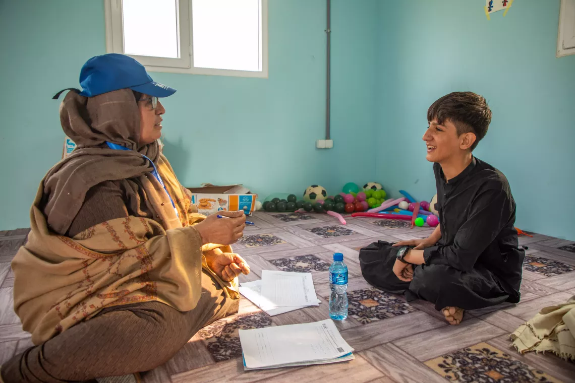 In December 2023, Matiullah speaks with a mental health counsellor at the UNICEF-supported drop-in center for unaccompanied and separated children in Nangarhar Province, Afghanistan.