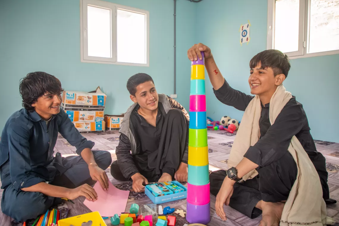 In December 2023, Matiullah plays with new friends at the UNICEF Drop In Center for unaccompanied and separated children in Nangarhar province, Afghanistan.