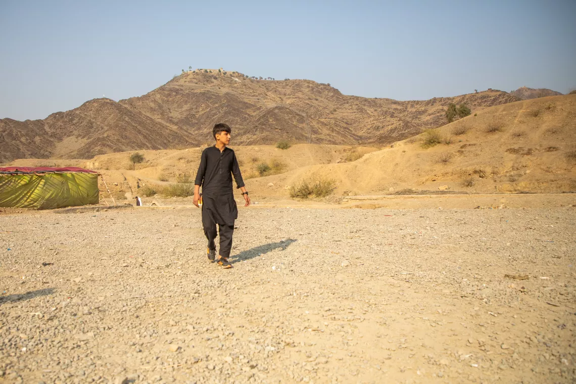 In December 2023, Matiullah is photographed in the desert near Afghanistan, where he tried to leave from Iran and Pakistan before UNICEF reunited him with his family.