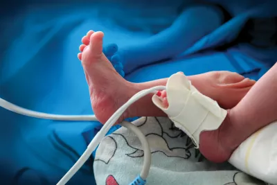 A newborn's foot in incubator in the hospital.