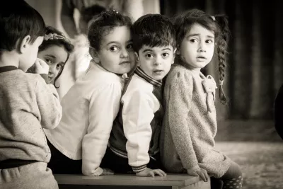 3 children in inclusive kindergarten sitting on the bench.