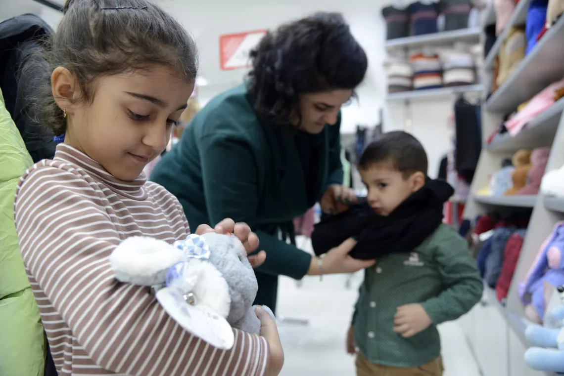  With the 25,000 AMD voucher, Lusine took her six-year-old son Grigory and seven-year-old daughter Anush on a shopping visit where she bought jeans, jumpers, warm coats, blankets and a cuddly toy.