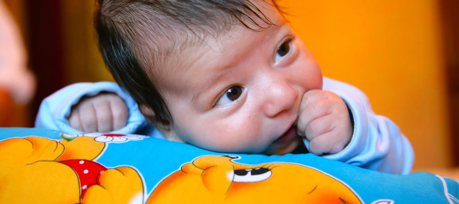 Two-month-old Vural Abdullayev lies on a blanket in his home in Baku.