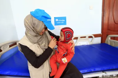 UNICEF staff holding a baby