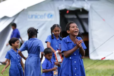 Fiona Dawn, 12 of Dreketi Primary School, smiles while standing in front of the newly set up UNICEF-supplied temporary school classroom.