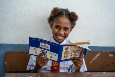 A student reads a story book during class at SD (elementary school) YPK Amos Tablanusu in Depapre, Papua Province, Indonesia