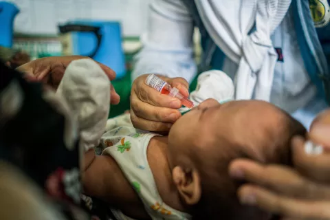  Nurse Jasmine Mandong gives the polio and pentavalent vaccines to 3-month-old Mohammed Zeyad, 