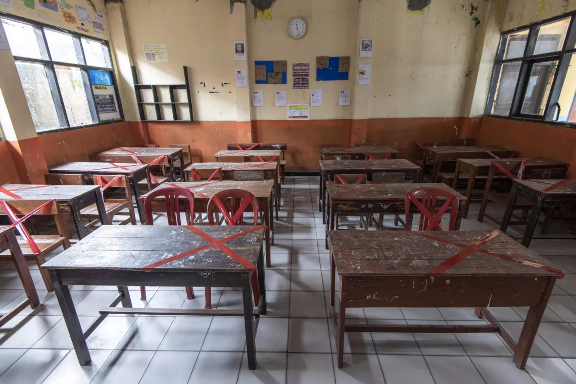 Desks and chairs are marked off to ensure that students keep a distance of 1.5 to 2 meters from each other while learning in class at SDN Sukamaju primary school in Bandung, West Java province, Indonesia