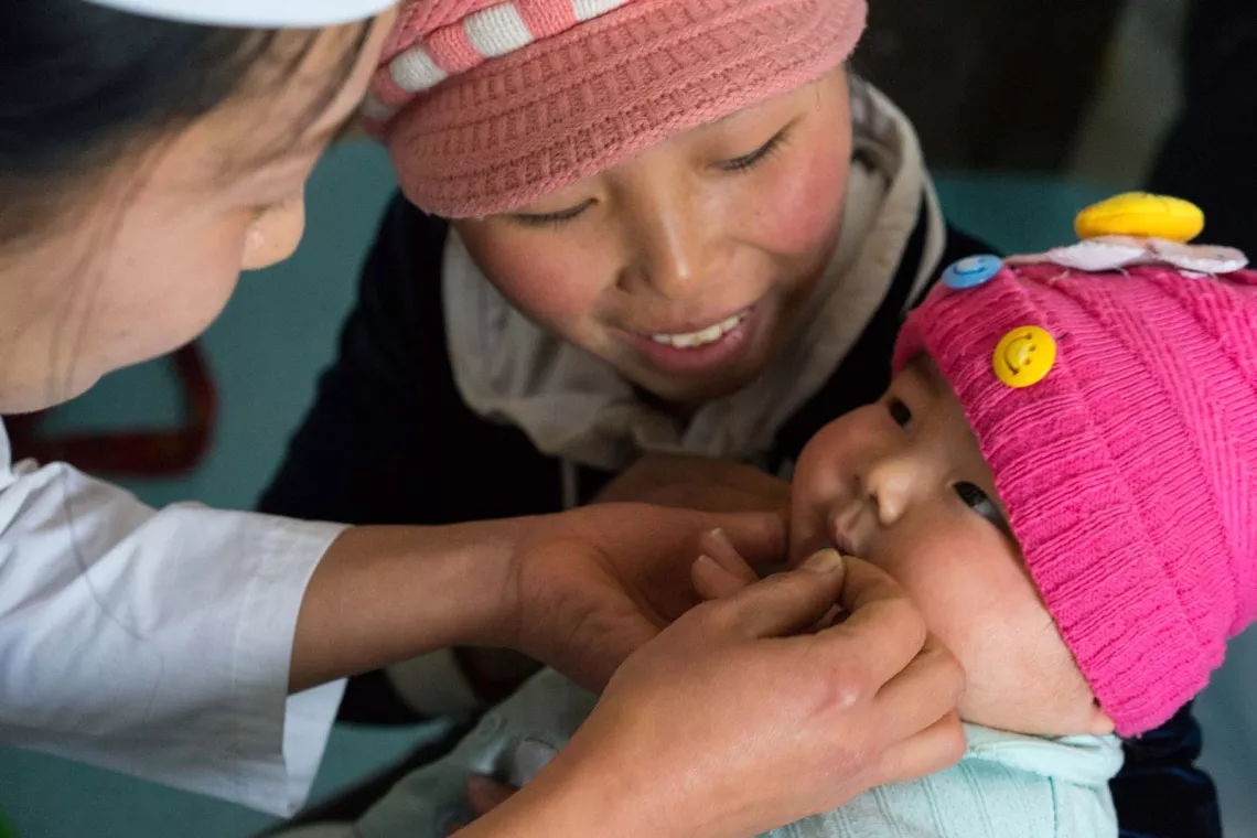 On 1 December 2016, children receive immunization, Vitamin A, deworming tablets and nutrition supplements in Kangan Ri, North Hamyong, DPR Korea