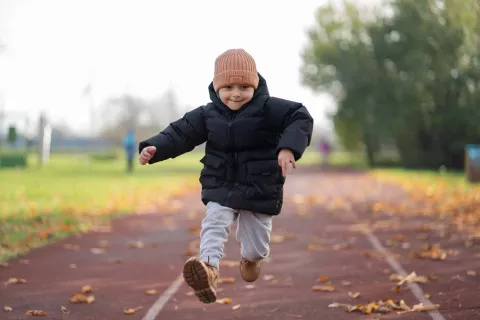 A Ukrainian boy jumps on a running track.