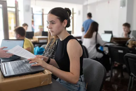 Girl works on computer in a shared learning space. 