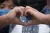 Tackling hate speech: A photo of a boy making the symbol of a heart with his hands