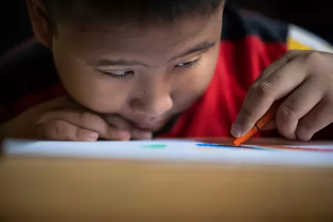Kevin draws with his crayon