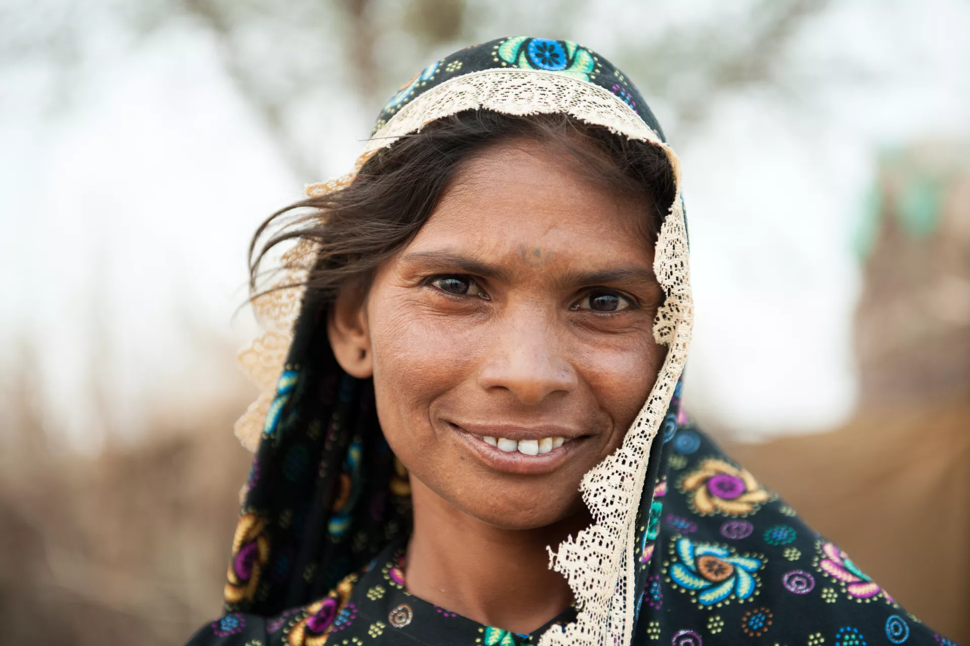 Woman from Pakistan smiling in front of the camera 