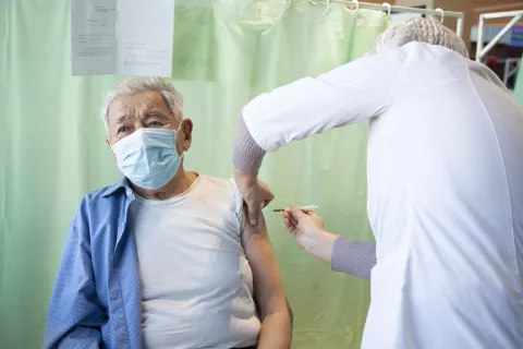 elder person taking a covid-19 vaccine shot
