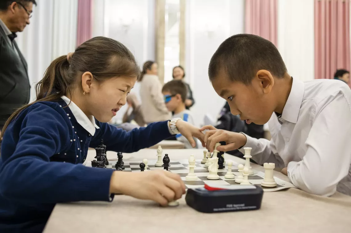 boy and girl playing chess