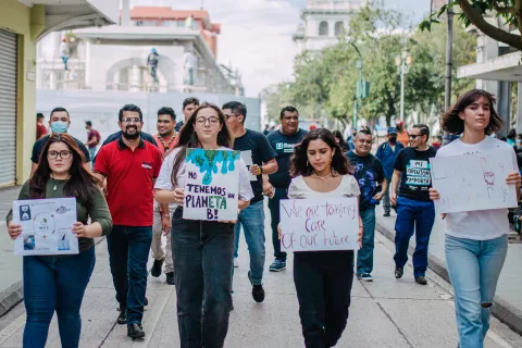 Miembros de U-report Guatemala marchan en una calle cercana al centro de la cuidad de Guatemala durante una marcha para crear consciencia del cambio climático