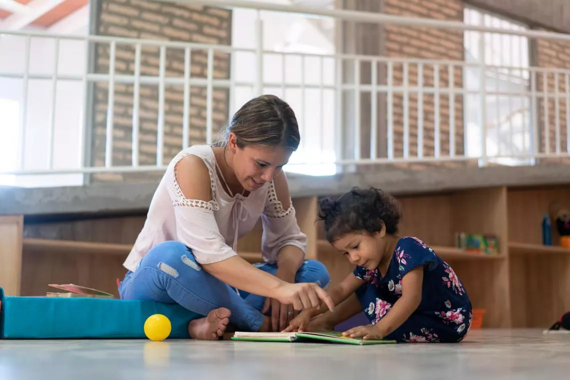 Selva, 2, engages in supervised play-based learning with a caregiver at the Torore centre, a UNICEF-supported Early Childhood Development (ECD) programme in Areguá, Central department, Paraguay.