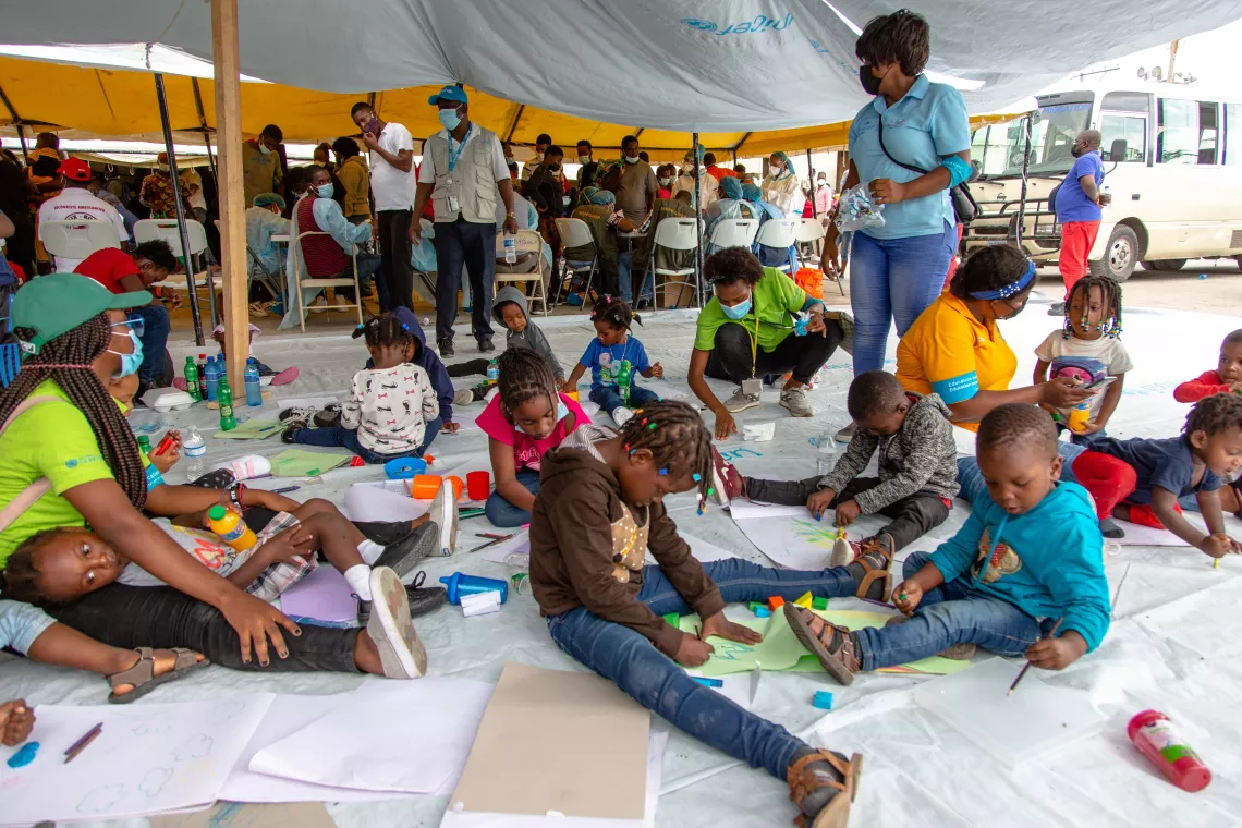 Children arriving from US border are playing with their peers and drawing with Haiti Kids Club staff while receiving psychosocial support at UNICEF's Child Friendly Center at Port au Prince Airport.