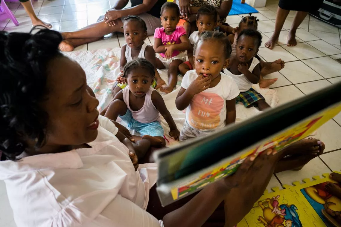 Children listen to a story at Shining Star Nursery  in Basseterre on St. Kitts, St. Kitts and Nevis.