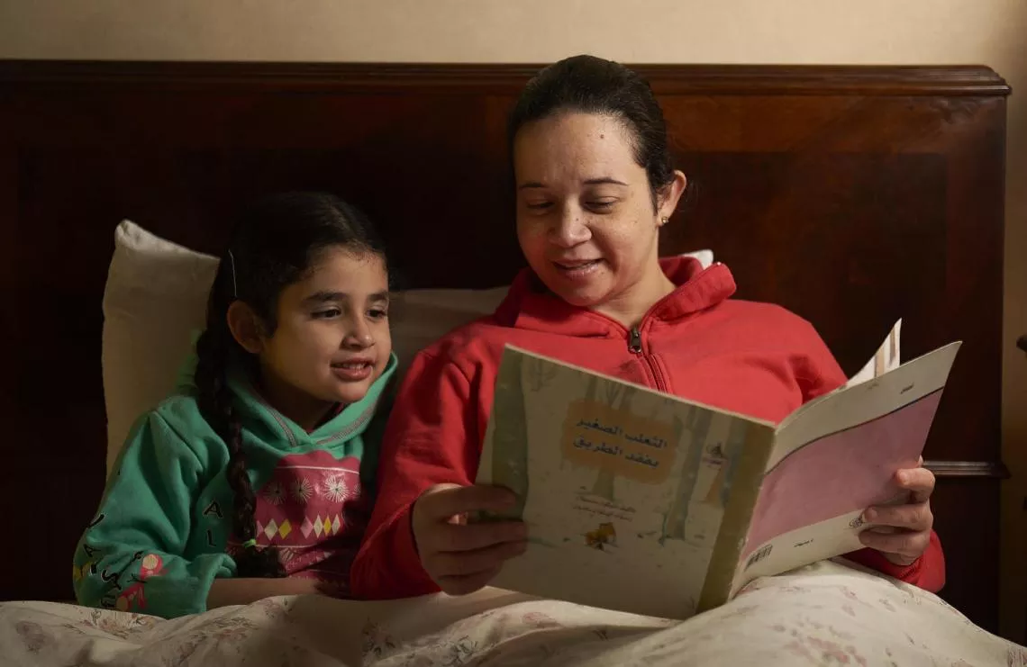 In Cairo, Egypt, a mother reads her daughter a bedtime story.