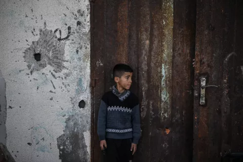 Young boy in front of wall