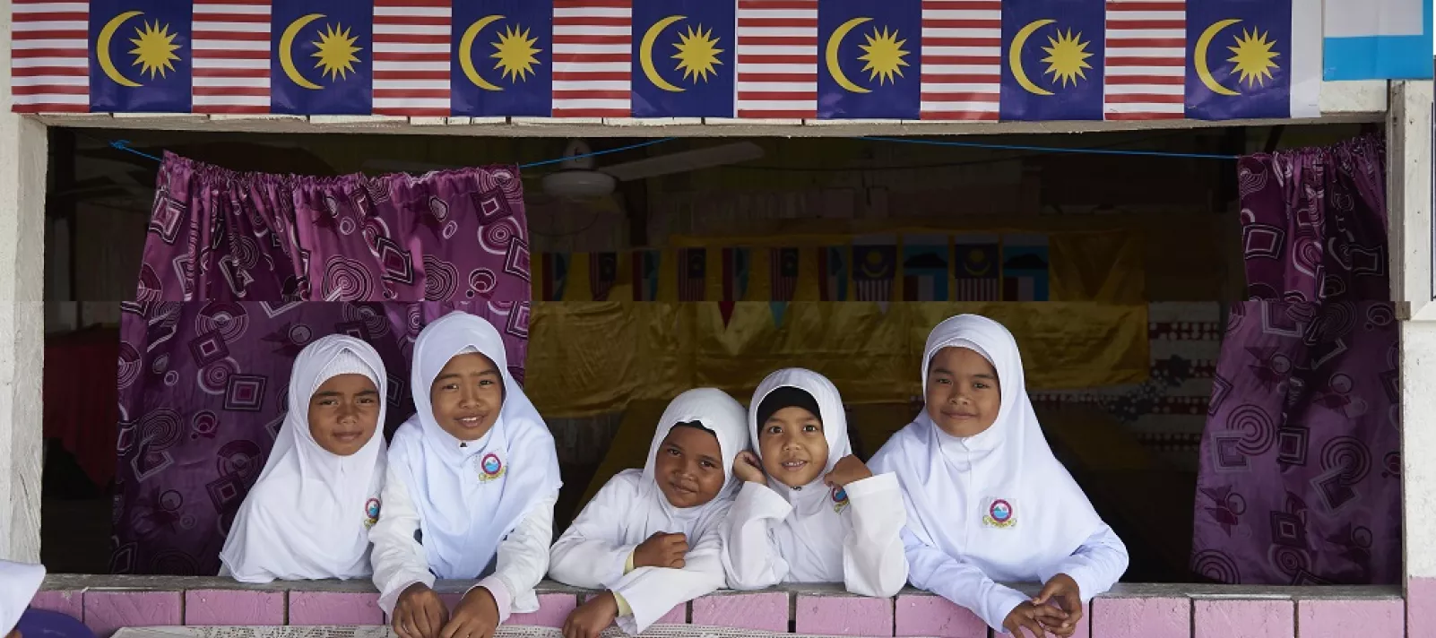 children in school with Malaysian flag