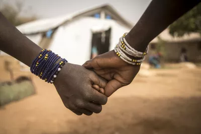 Fatoumata* and Aichata*, both 12, hold hands at a newly created displacement site in Sevare.