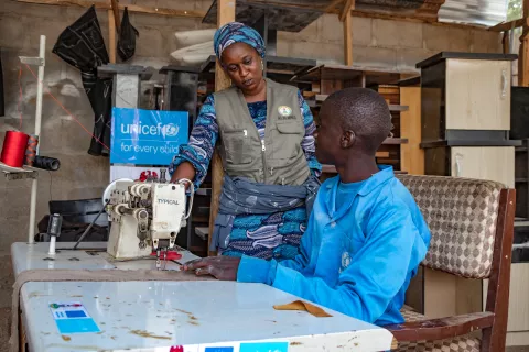 A social worker discussing with an adolescent in a vocational training center supported by UNICEF