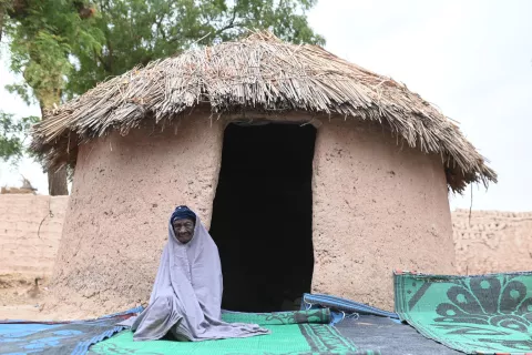 Hajia Kaka 104, sits in front of her hut in Tsalibawa Village, Sokoto state.