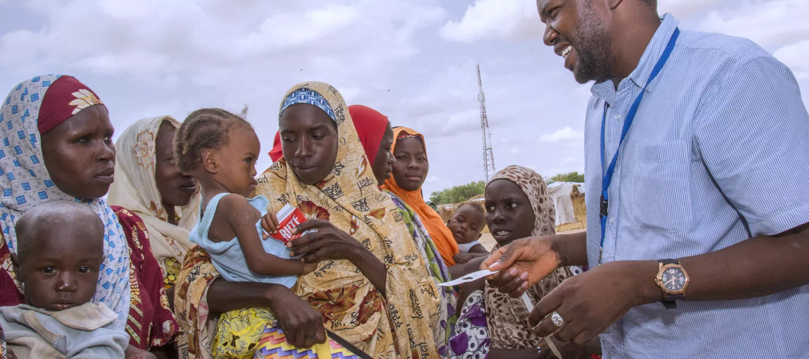 A UNICEF staff gives a mother therapeutic food for her baby