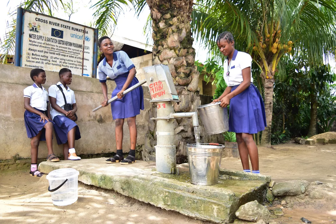 Schoolgirls get safe water from a water facility near their homes
