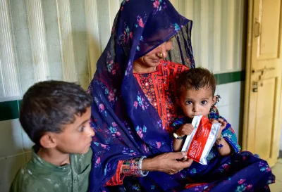 Ten-month-old Zarrine, who has been screened to be a case of Severely Acute Malnutrition (SAM), sucks onto Ready-to-Use Therapeutic Food (RUTF) provided to her mother, Lal Bibi, as a treatment for SAM, at the Basic Health Unit, Allah Yar Khosa in Jaffarabad District of Balochistan province in Pakistan.