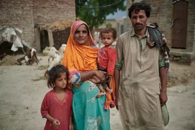 Reshma stands holding his son Azaan Ali (16 months old) Fiza, 6,her daughter and Saaein Bakhsh , her husband, at Village Ismail Bhand, Shaheed Benazirabad district, Sindh province, Pakistan