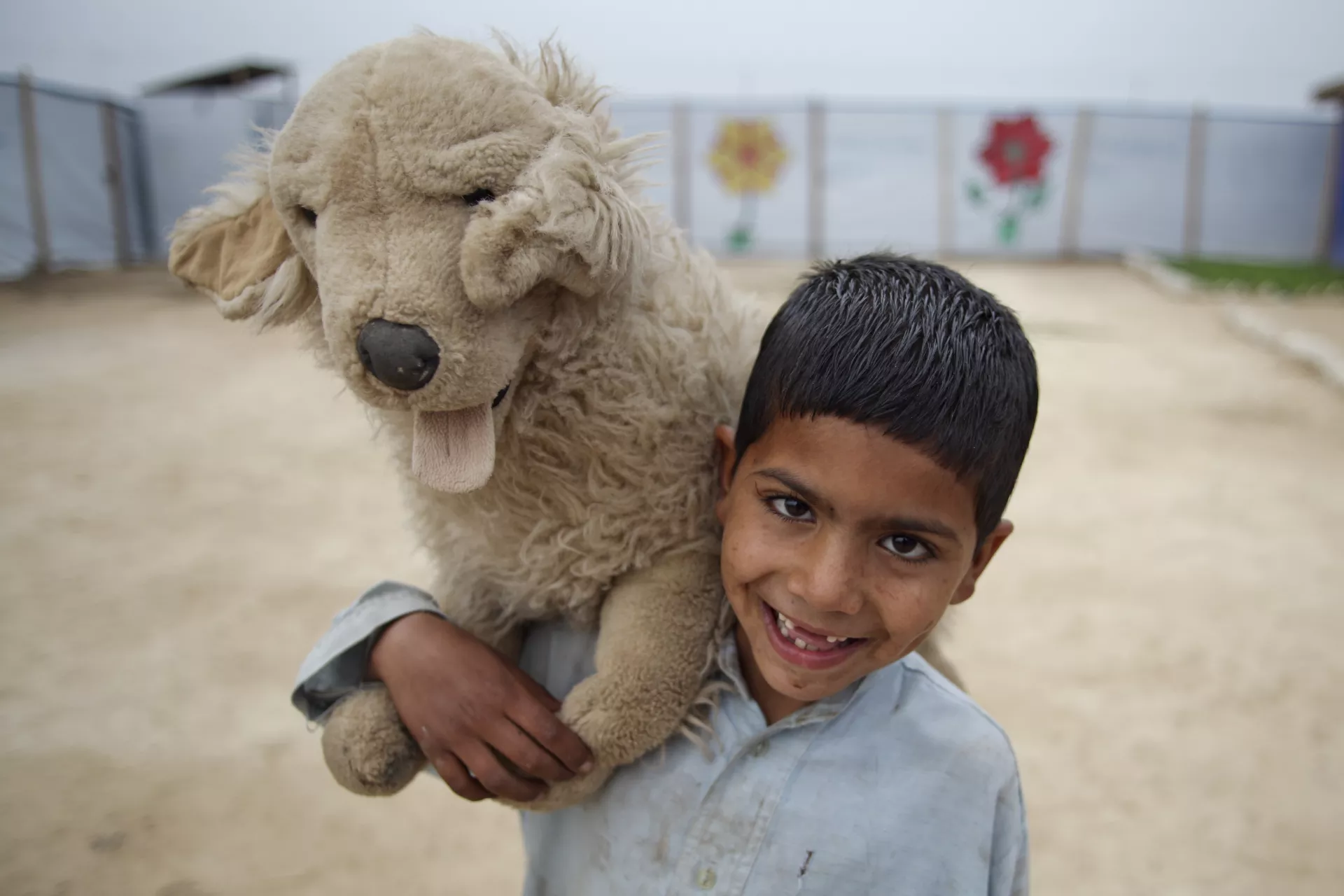 5 year old Daniyal plays with a stuff toy in Jalozai Camp, KPK province in Pakistan