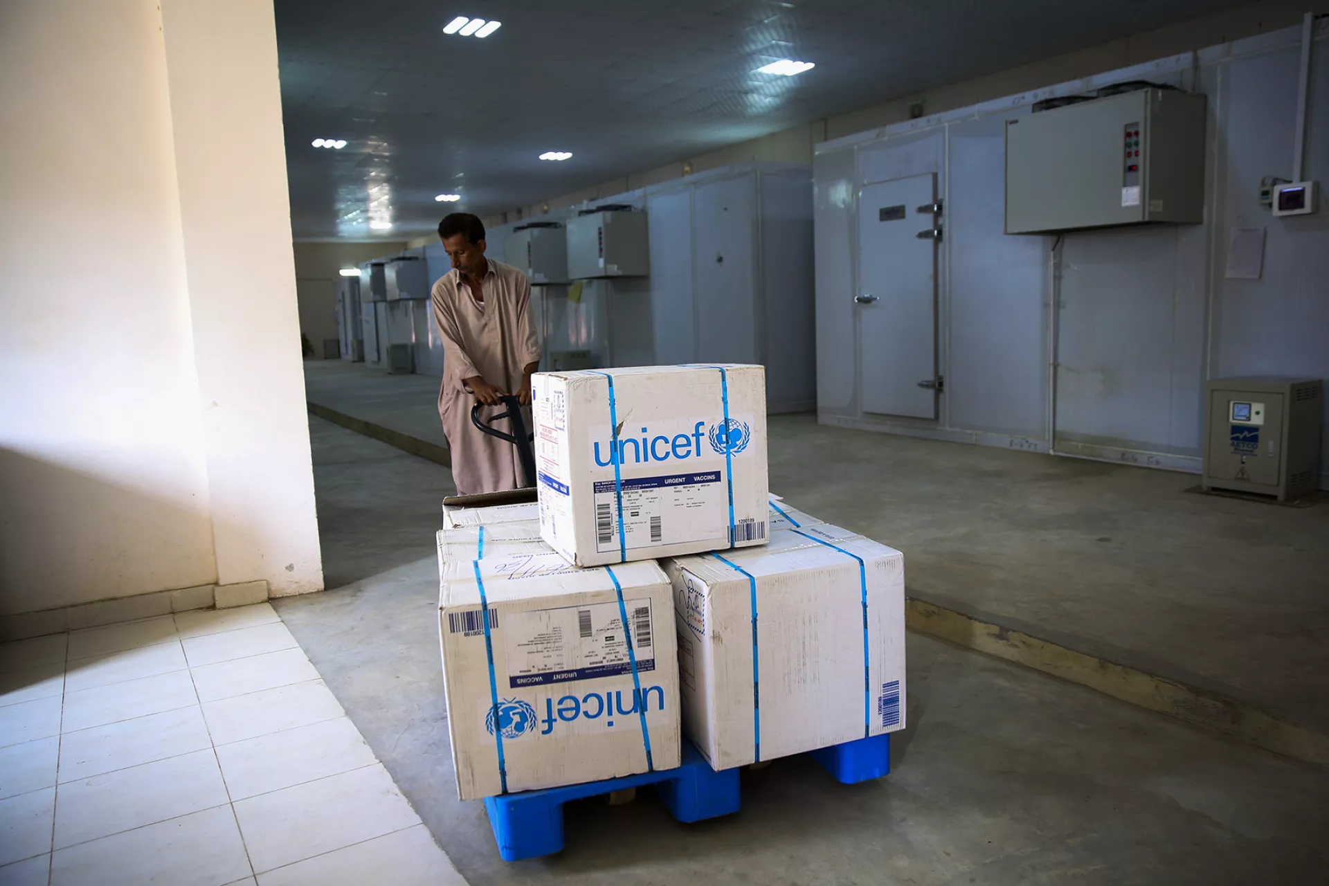 A man transports vaccines in a warehouse