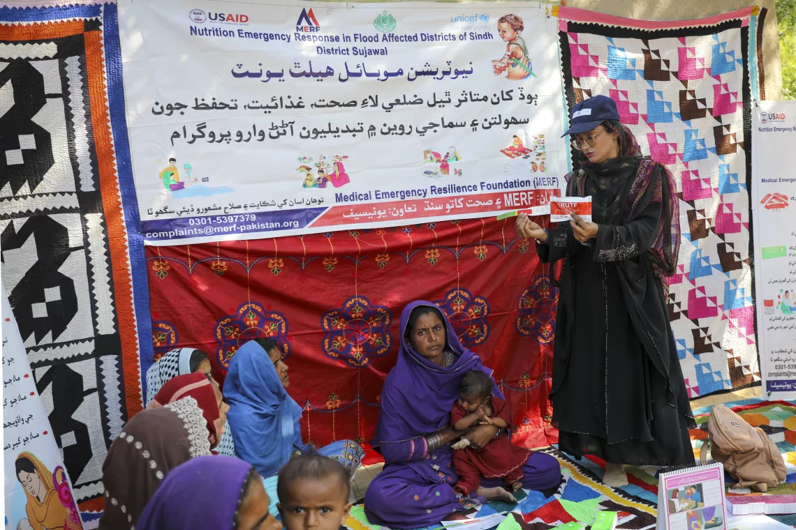 Nutrition Assistant Umbreen conducts a community session for mothers on screening and treatment methods for malnutrition.
