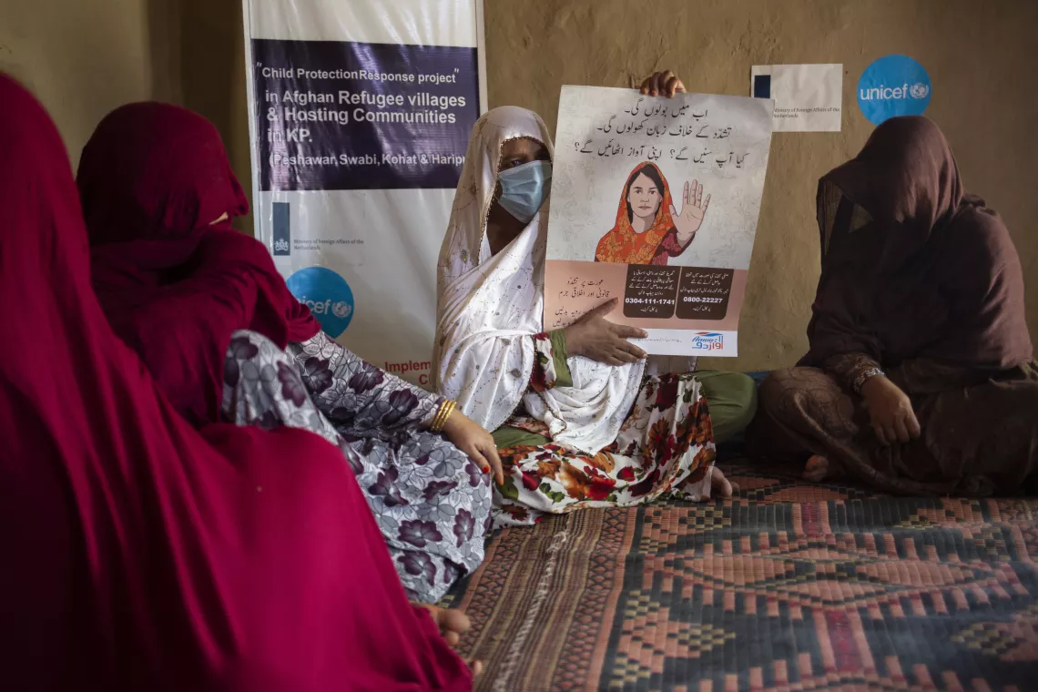 Bus Bibi leads a session during a monthly Child Protection Committee meeting in her community.