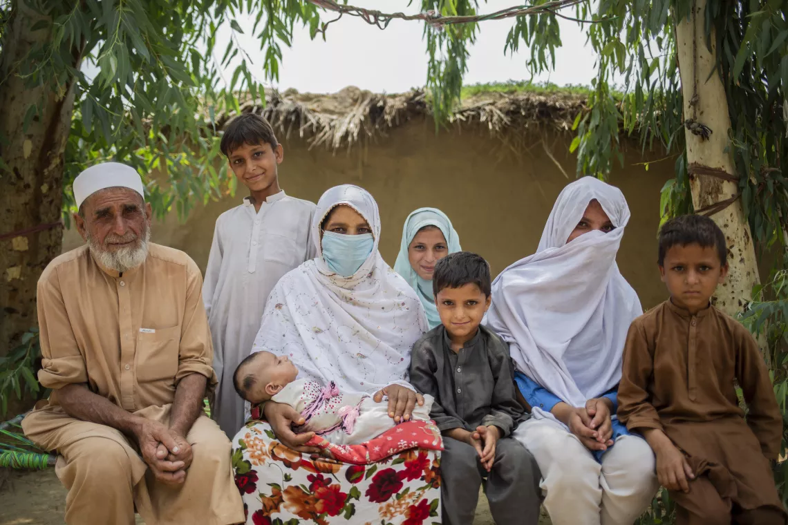 Bus Bibi poses with her husband, Mohammad Ashiq and six of her eight children, including Aqeela (14).