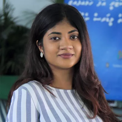 Fathimath smiles at the camera