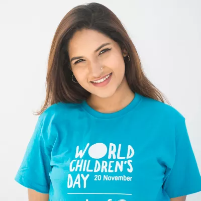 Raba smiles in a World's Children's Day shirt